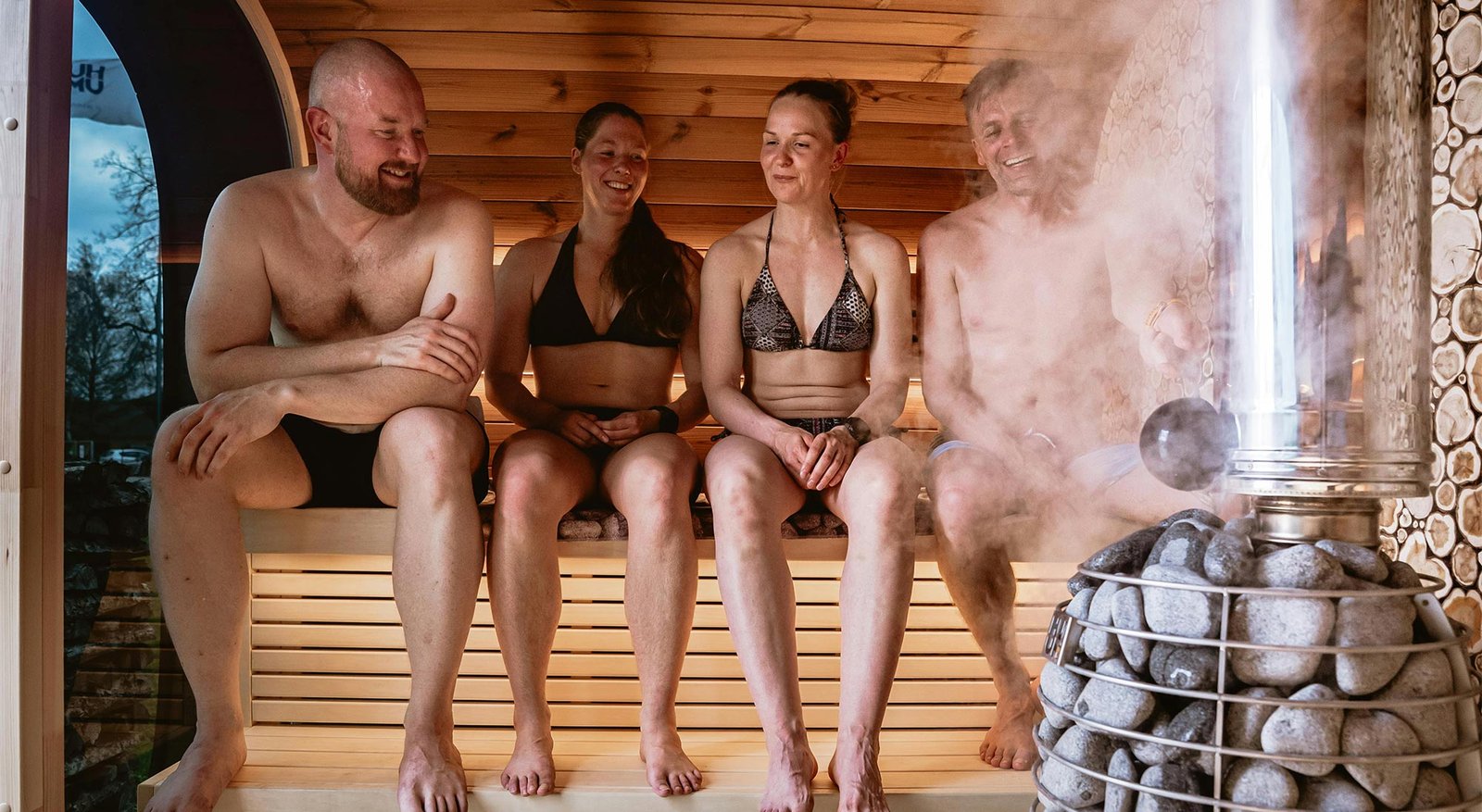Friends relaxing inside a Sacred Sauna